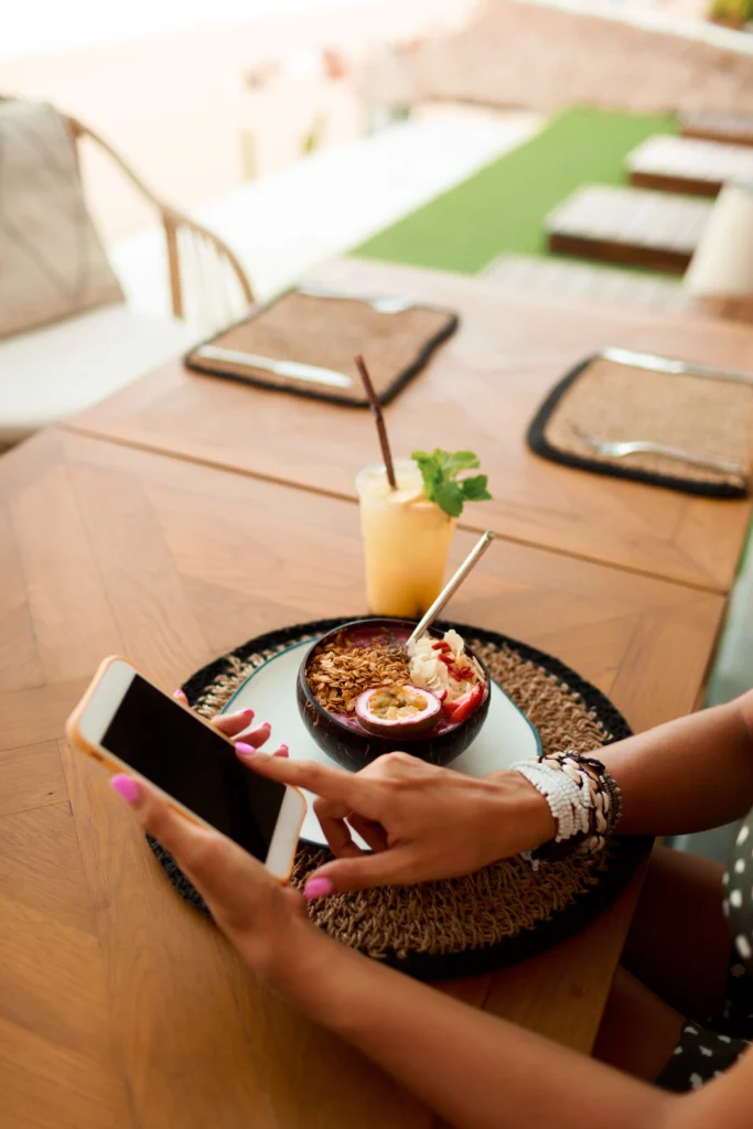 european woman using mobile phone cafe