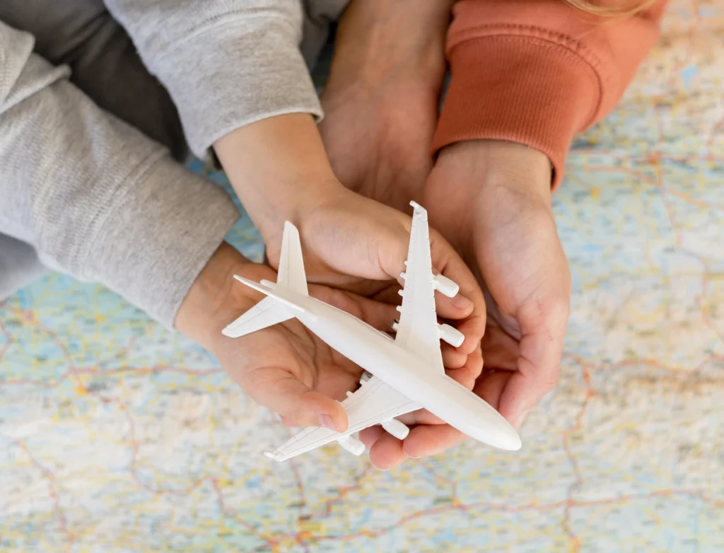 mother child home holding airplane figurine top map