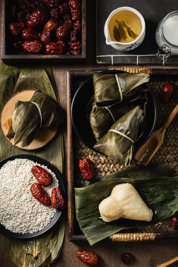 vertical closeup shot preparation rice dumplings with banana leaves 1